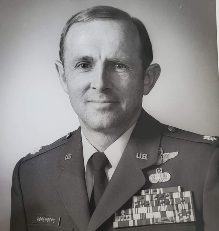 Roger Korenberg climbing aircraft in flight suit during early career